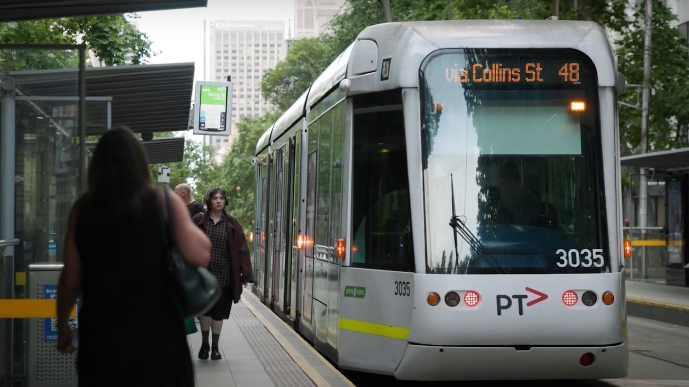 Photo of a tram at a tram stop on a Melbourne street