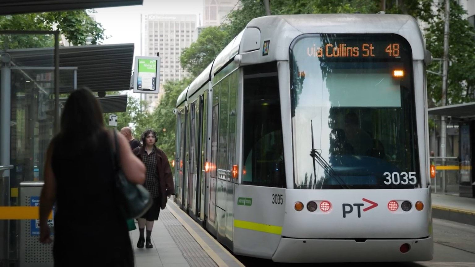 Photo of a tram at a tram stop on a Melbourne street