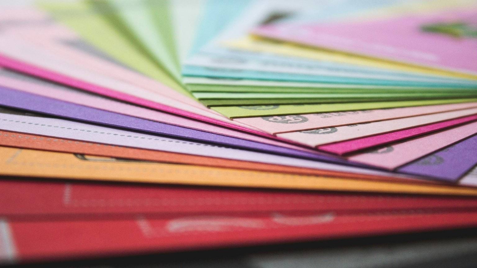 Colourful folders spread out on table